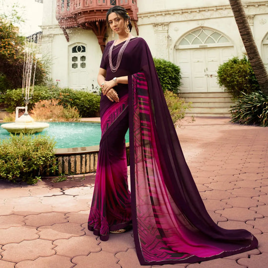 Woman in a deep shade purple jacquard work saree with gold border standing indoors in an elegant room with arched decor and vintage furniture elements