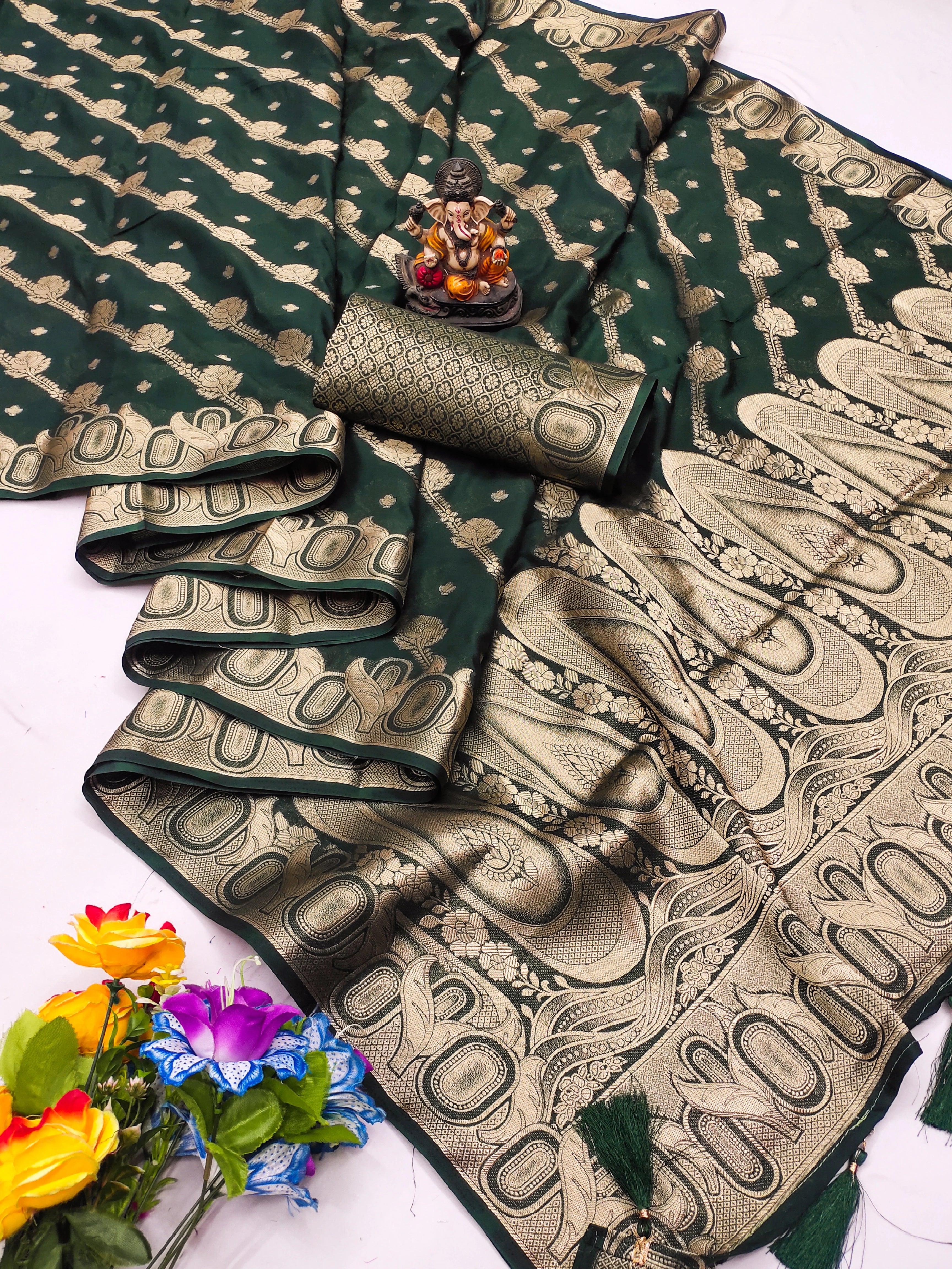 Green and gold saree with floral decorations on a white background