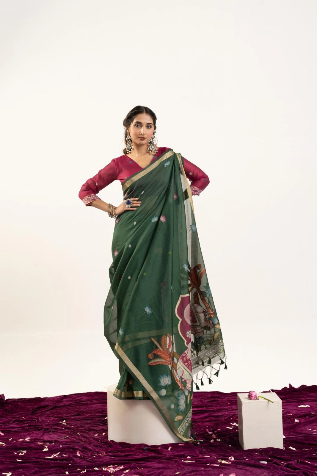 Woman wearing a green saree with a white background