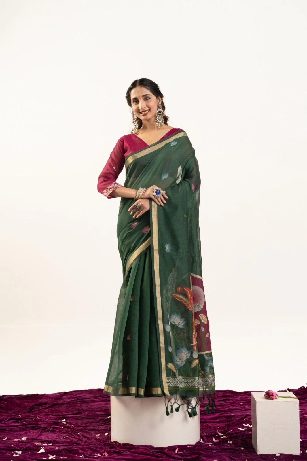Woman wearing a green saree with a white background