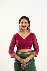 Woman wearing a red blouse with green saree on a white background