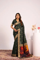 Woman wearing a green saree with a colorful border against a white background