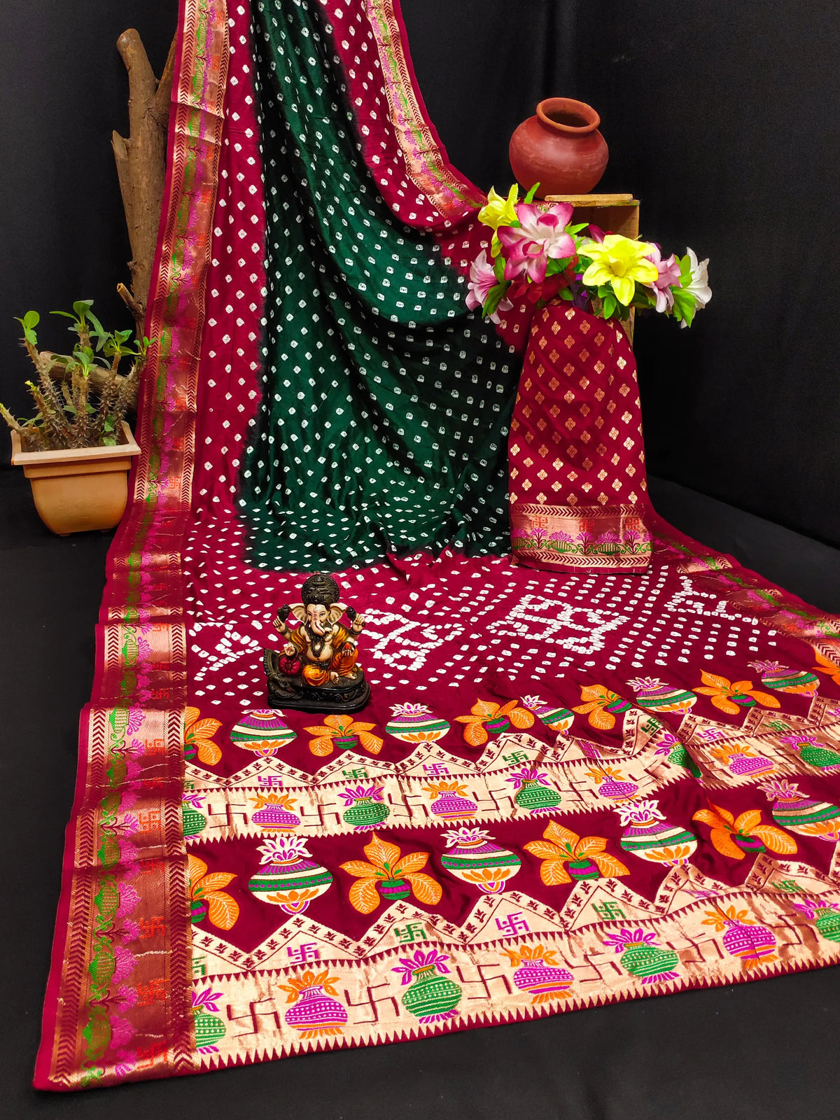 Colorful embroidered fabric with patterns and a small statue on a dark background