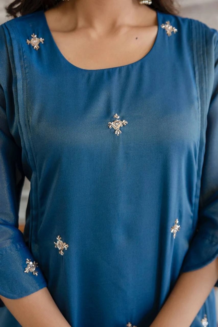 Blue top with decorative elements on a person