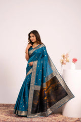 Woman wearing a blue saree with a white background