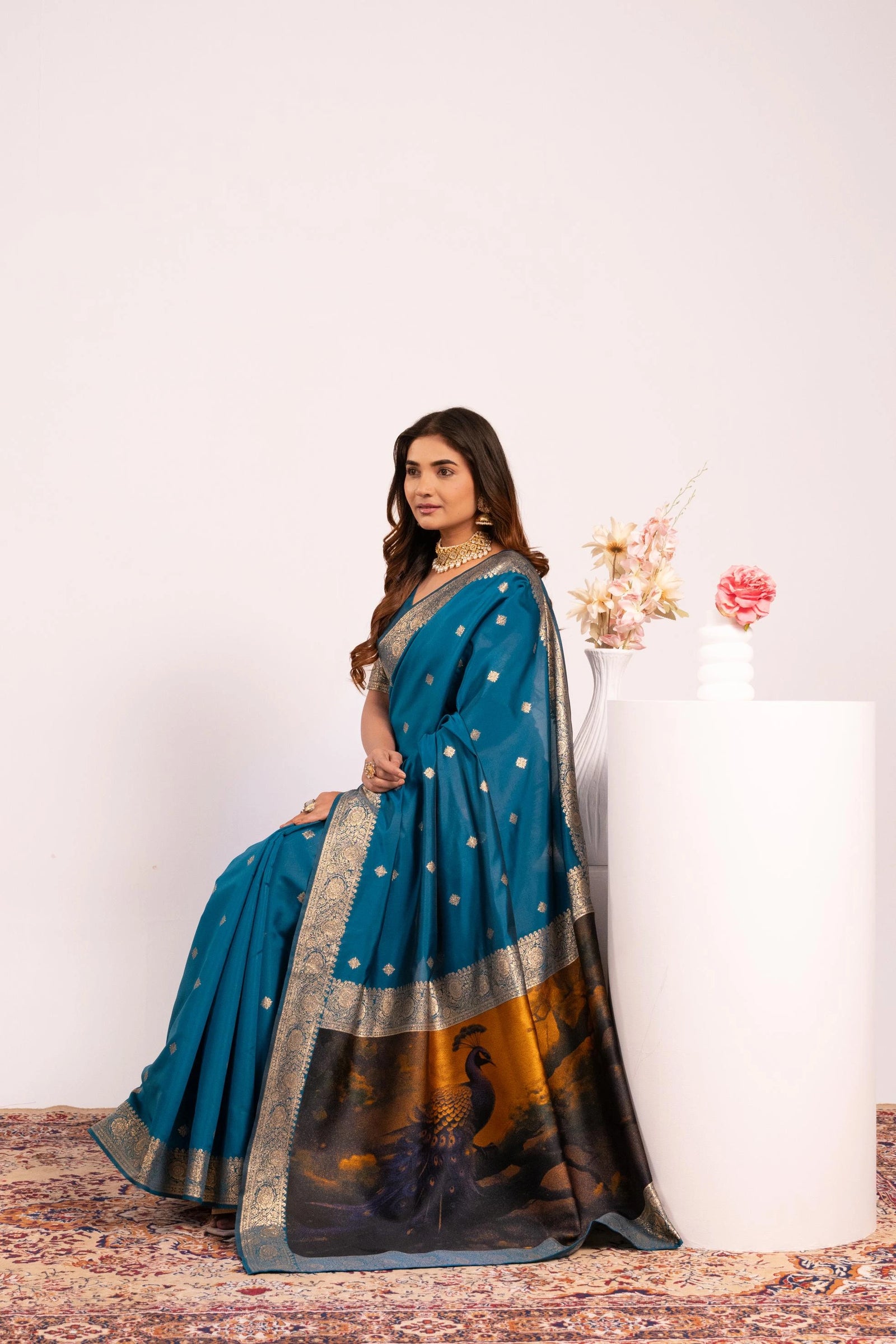 Woman wearing a blue saree with a white background
