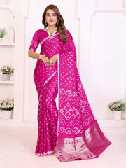 Woman wearing a pink saree with white patterns in a minimalistic setting