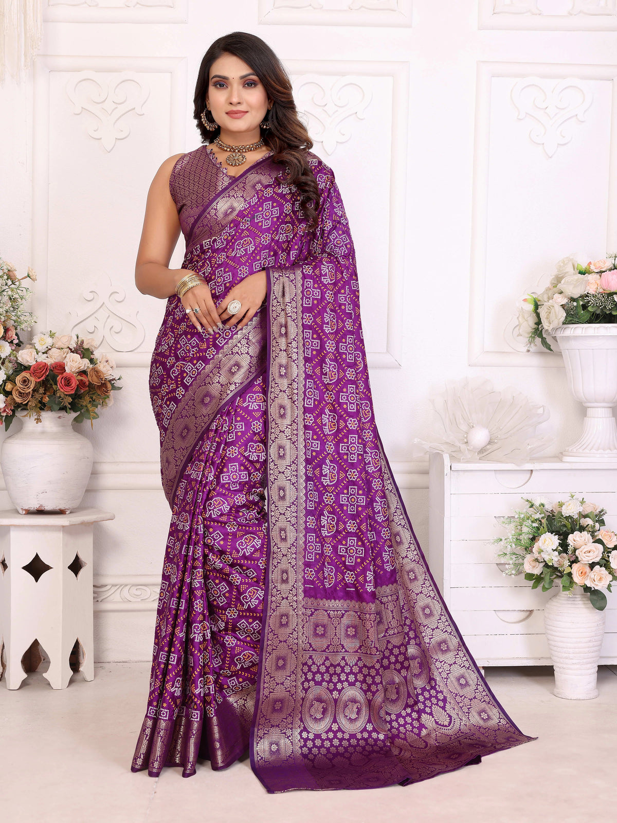 Woman wearing a purple saree with a white background