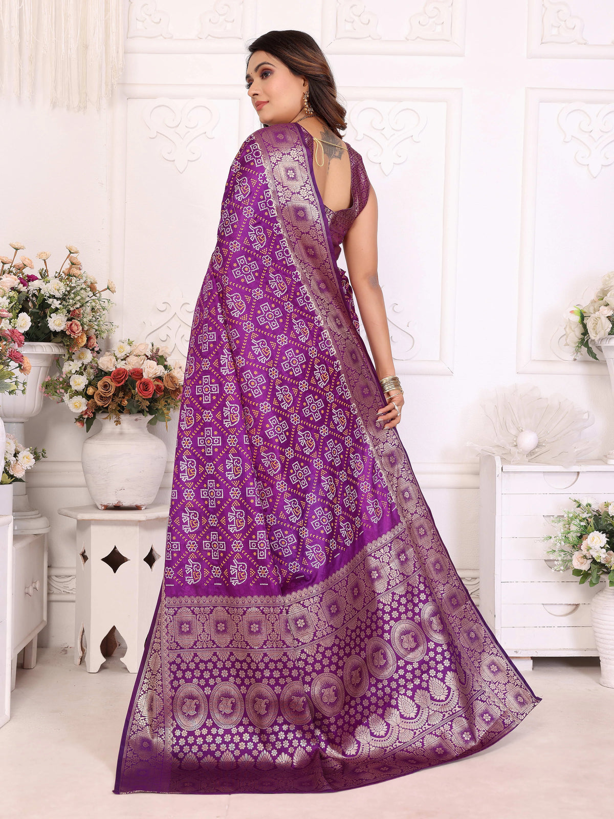 Woman wearing a purple saree with a white background
