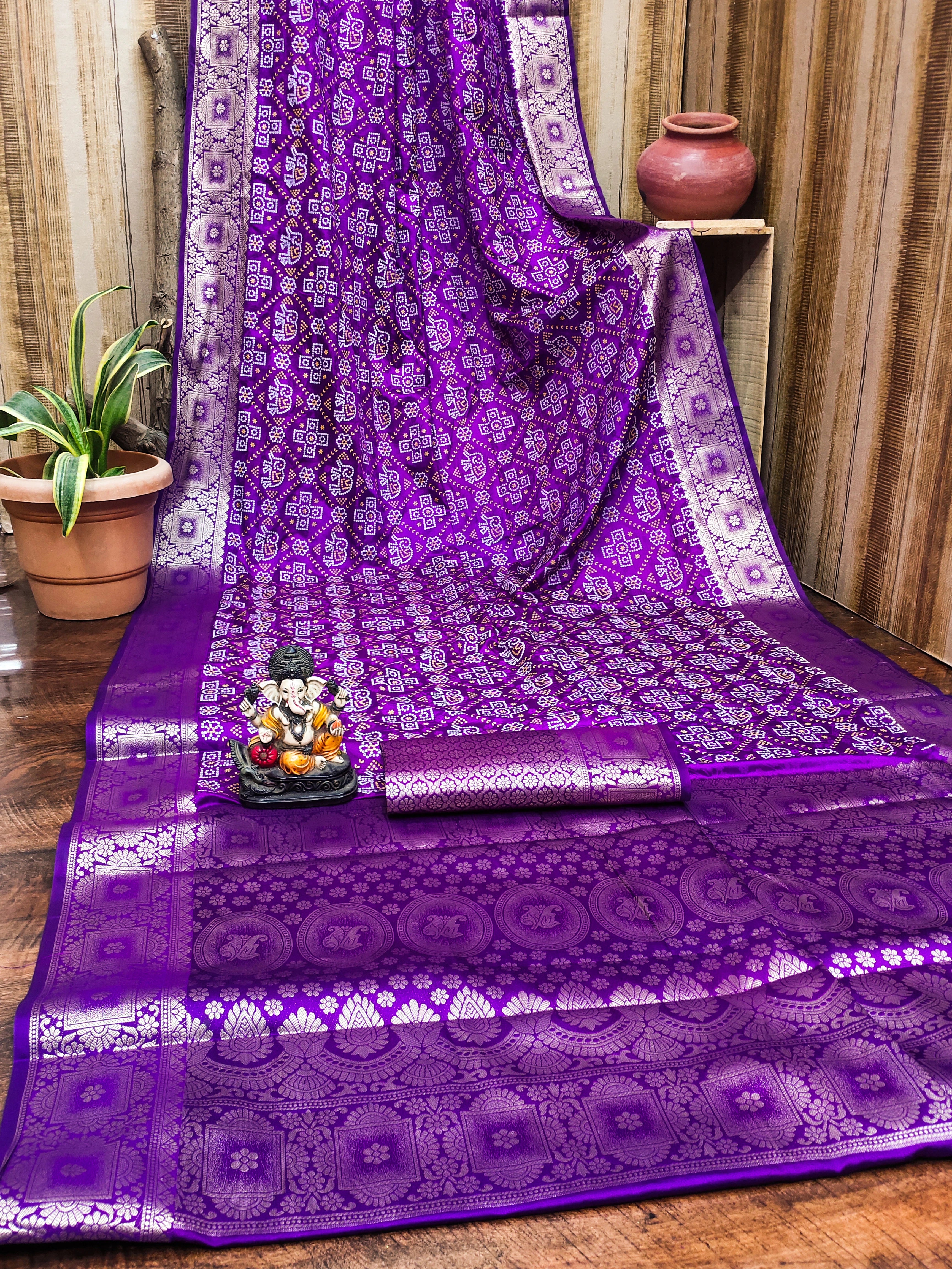 Purple saree with white patterns on a wooden floor