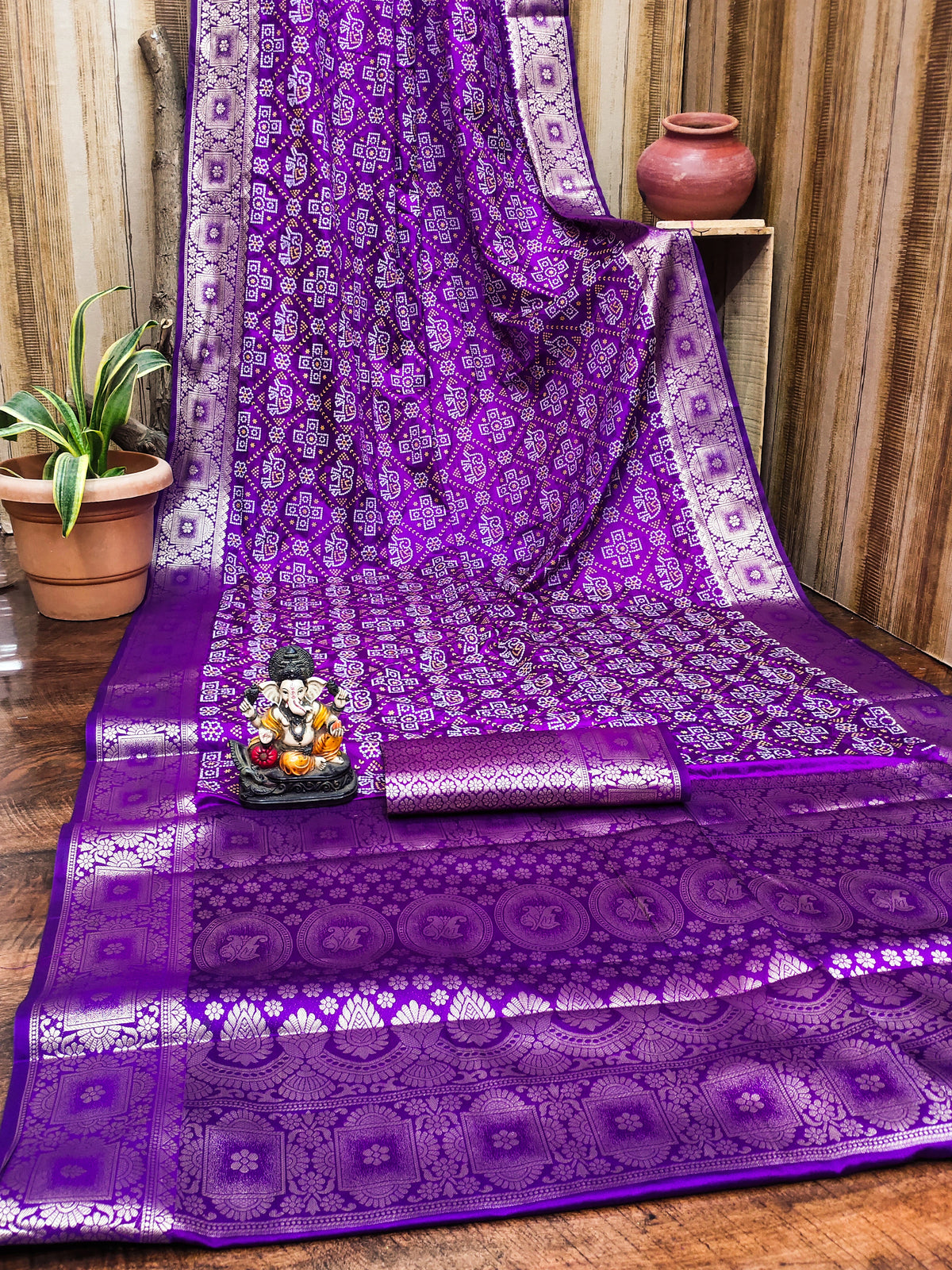 Purple saree with white patterns on a wooden floor