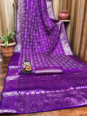 Purple saree with white patterns on a wooden floor