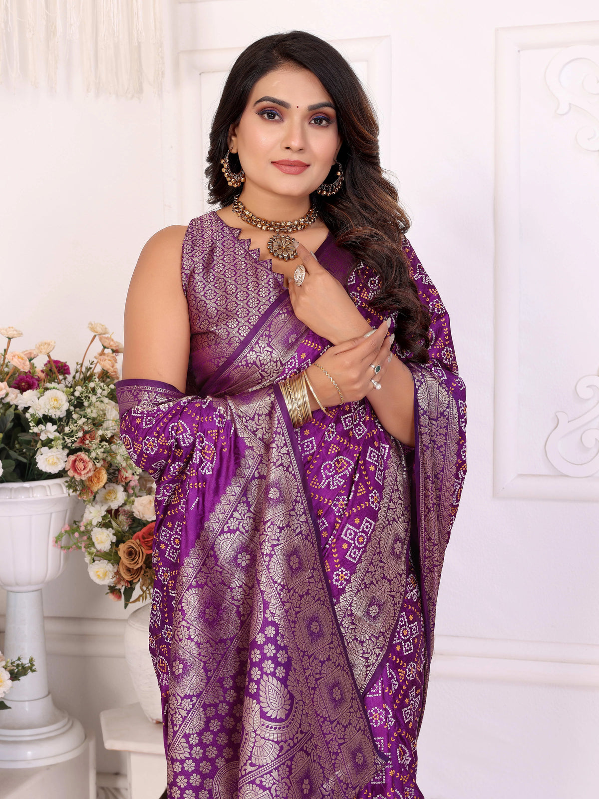 Woman wearing a purple saree with a white background