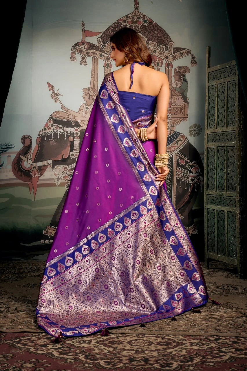 Woman wearing a purple saree with a traditional backdrop