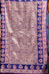 Decorative fabric with intricate patterns in purple and pink on a blue background