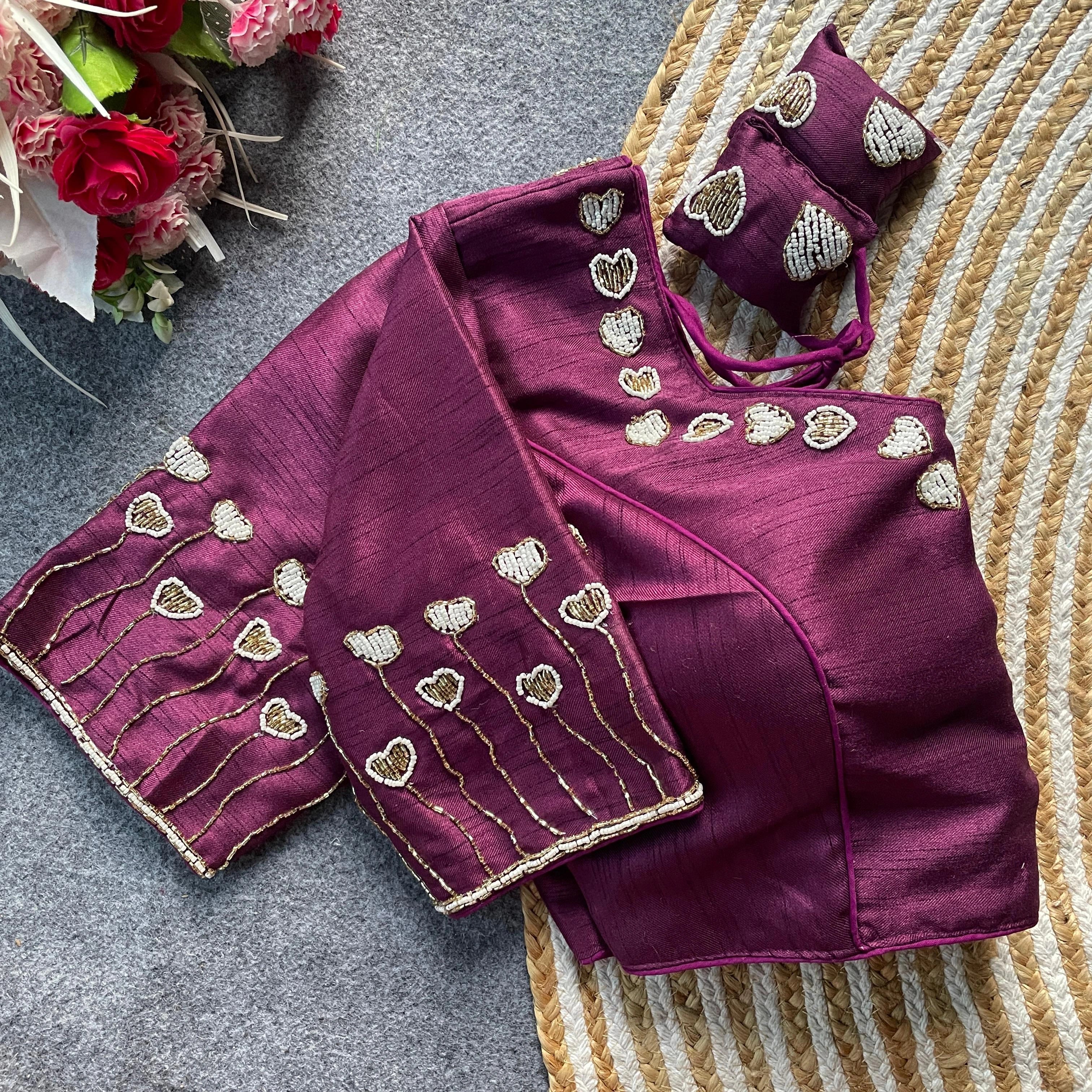 Purple saree with gold heart patterns on a textured surface