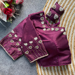 Purple saree with gold heart patterns on a textured surface
