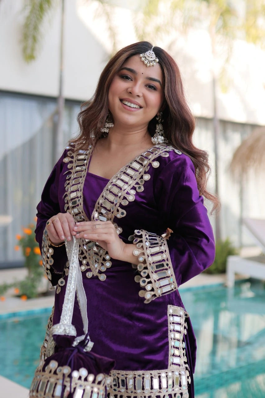 Woman in a purple traditional outfit with decorative elements, standing outdoors.