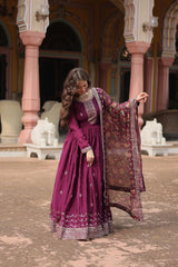 Woman in a traditional outfit standing in an ornate architectural setting
