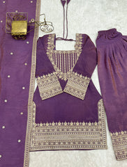 Purple traditional outfit with intricate silver embroidery on a light gray background