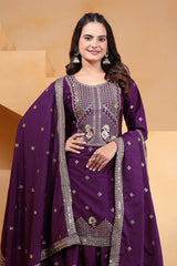 Woman wearing a purple traditional outfit with intricate designs on a beige background