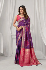 Woman wearing a purple and pink saree with a white curtain background