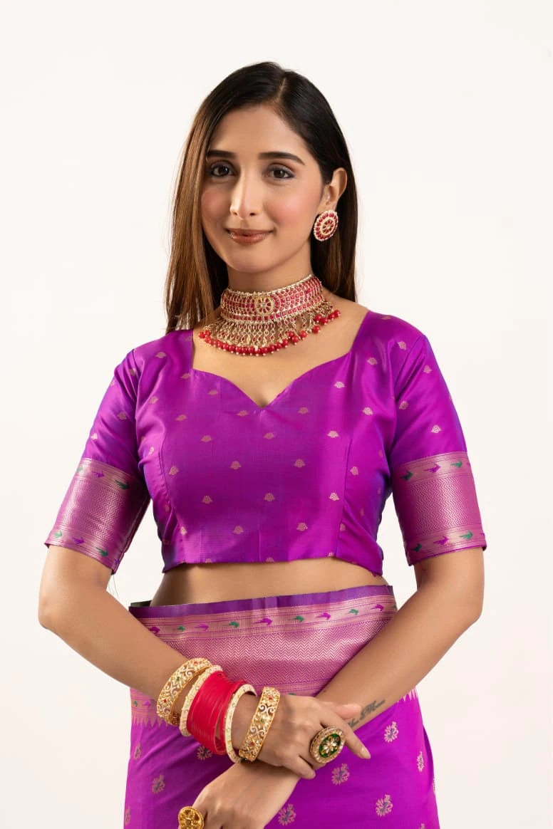 Woman wearing a purple traditional outfit with jewelry on a white background