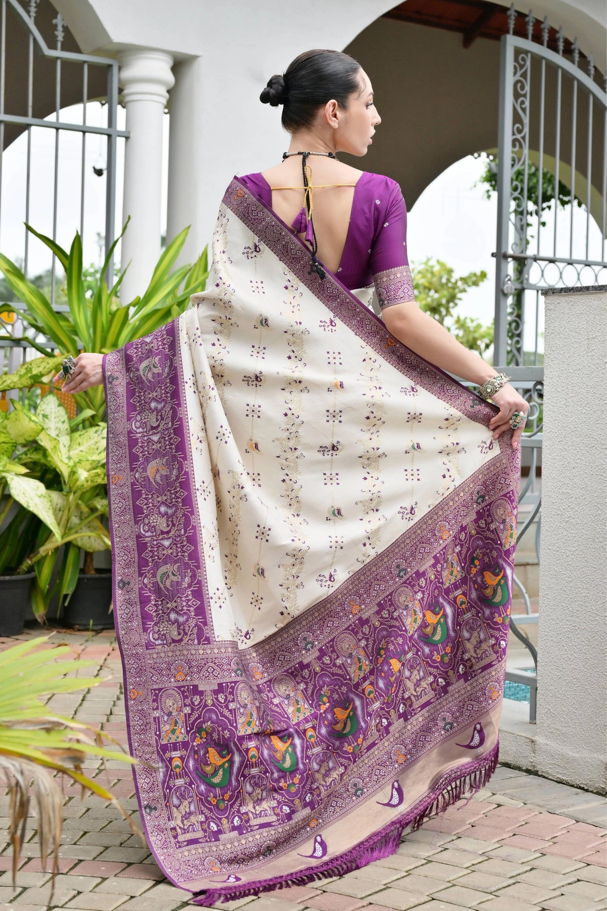 Close-up of deep purple silk saree highlighting delicate golden zari craftsmanship