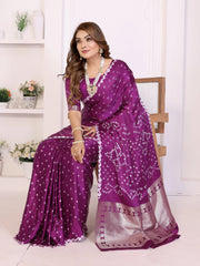 Woman wearing a purple saree with a white background