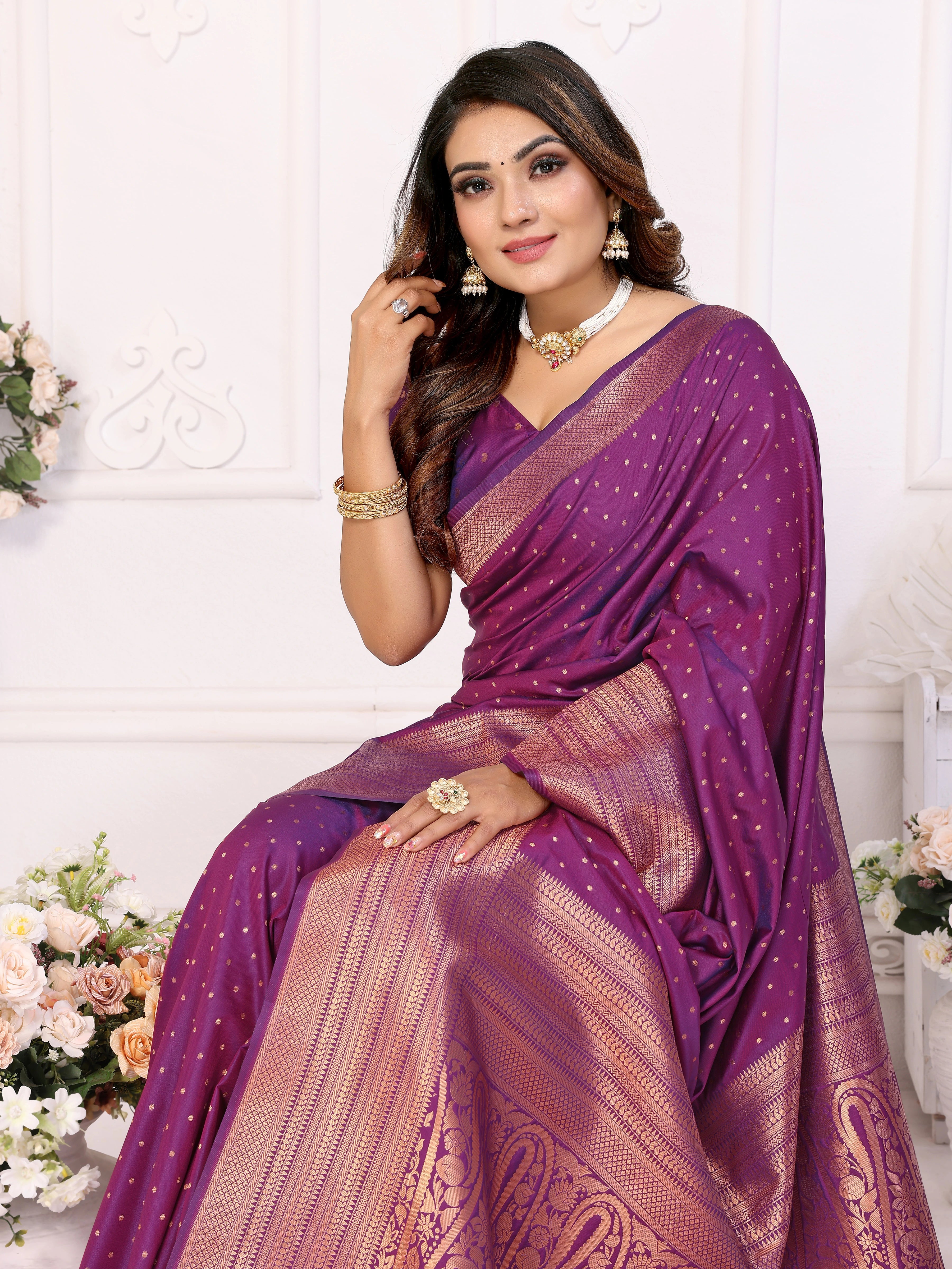 Woman wearing a purple saree with a white background