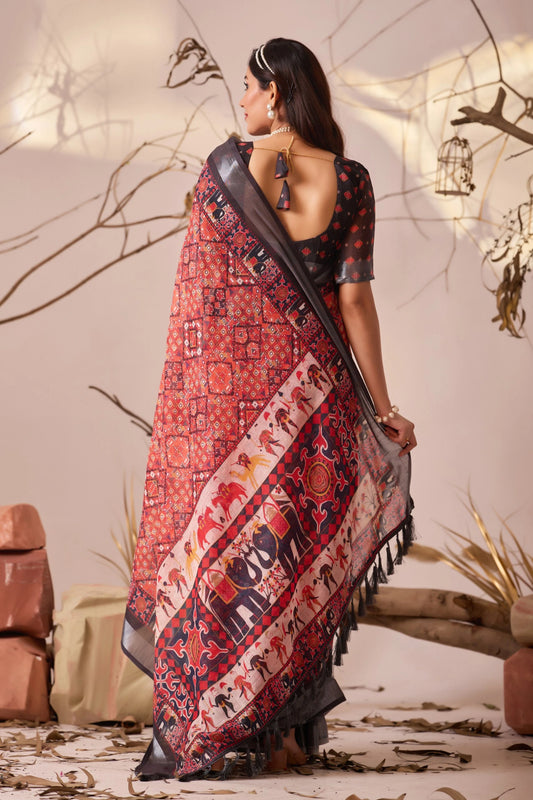 Woman wearing a traditional saree with intricate patterns in a decorative setting.