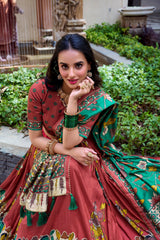 Elegant maroon Kalamkari printed saree with emerald green floral pallu and artistic traditional border.