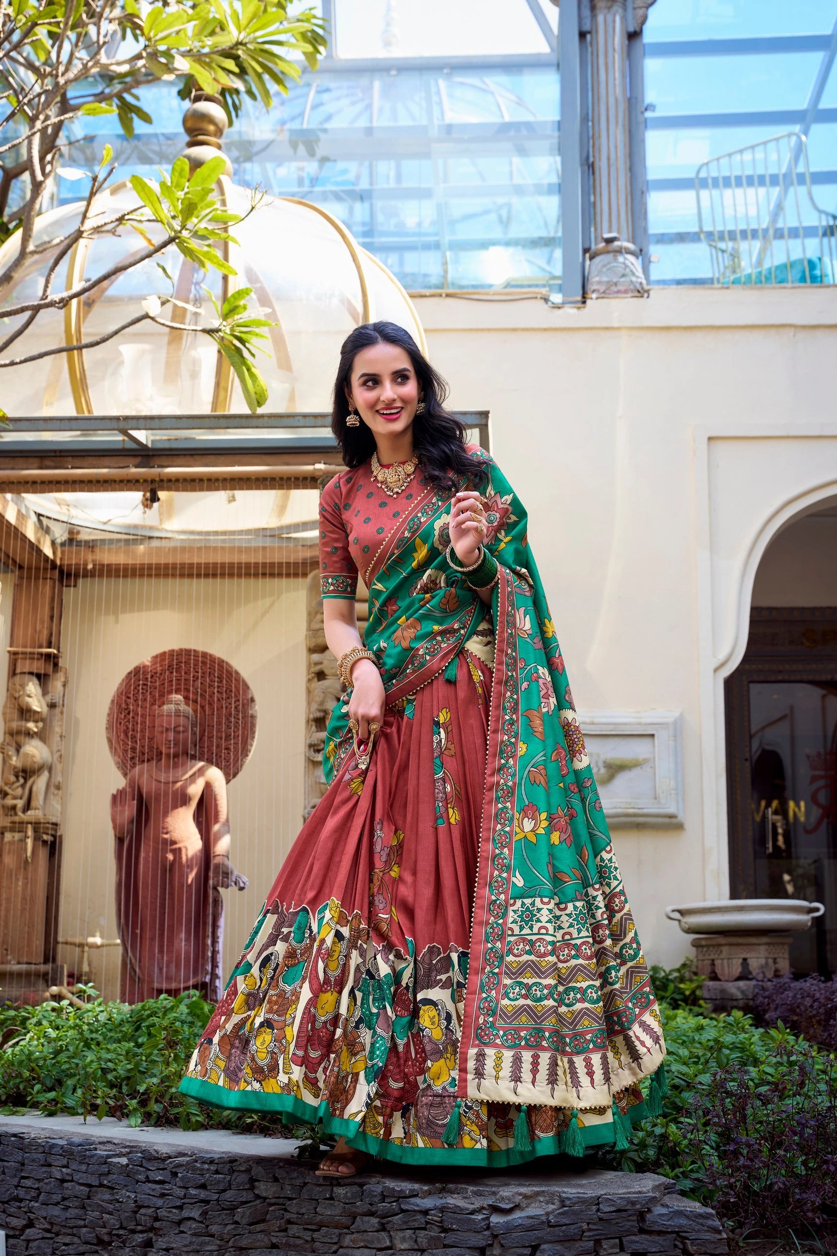 Premium maroon ethnic saree with handcrafted Kalamkari artwork, green floral pallu, and festive elegance.