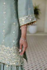 Close-up of a light blue embroidered garment with intricate patterns.