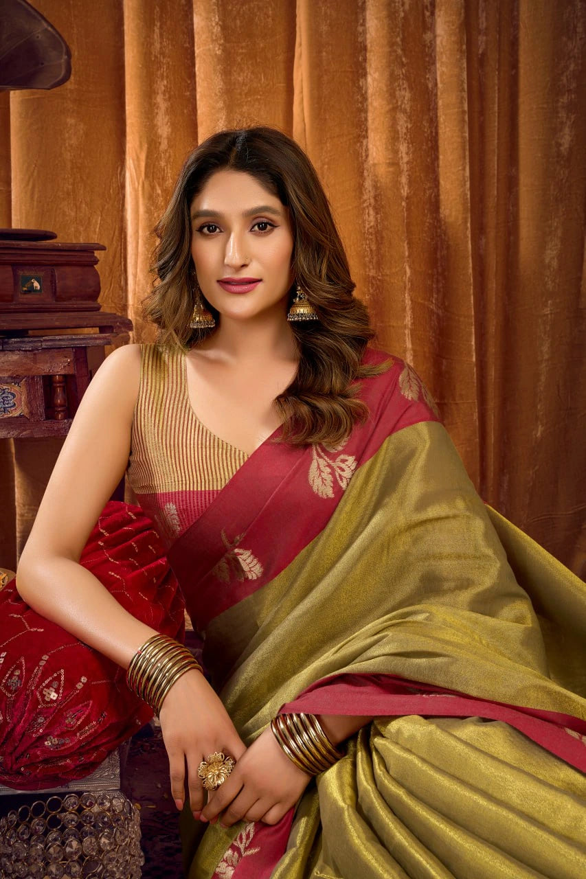 Woman wearing a red and gold saree with a wooden background