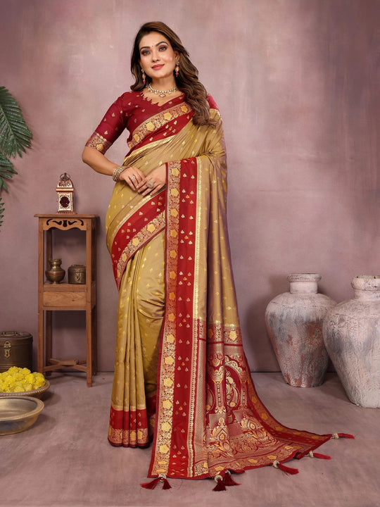 Woman wearing a red and gold saree with a neutral background