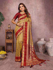 Woman wearing a red and gold saree with a neutral background