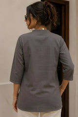 Back view of gray cotton floral print short kurti showing full back coverage with clean finish and 3/4 sleeves