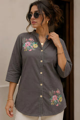 Close-up of gray short kurti showing collar neckline, wooden button placket, and vibrant floral bouquet print in pink, yellow, and green