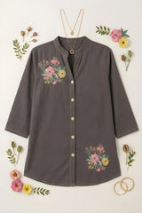 Gray floral print short kurti flat lay with gold necklace, bangles, and fresh pink and yellow flowers, front button placket visible
