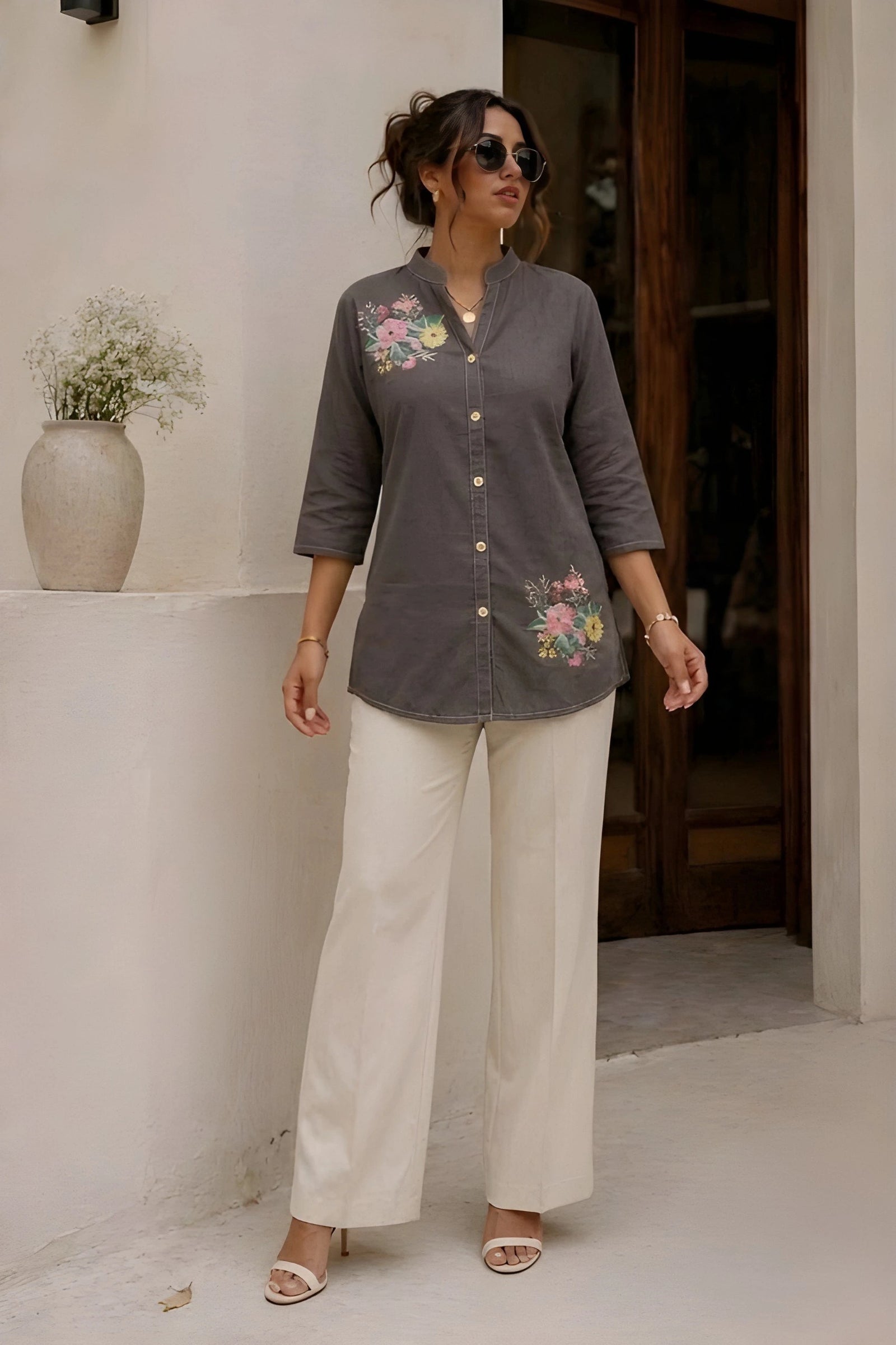 Gray floral print short kurti full length front view, model in white wide-leg trousers and heeled sandals, collar neckline with button placket