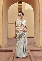 Woman in a saree standing in front of an archway