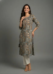 Woman wearing a patterned kurta with white pants against a gray background