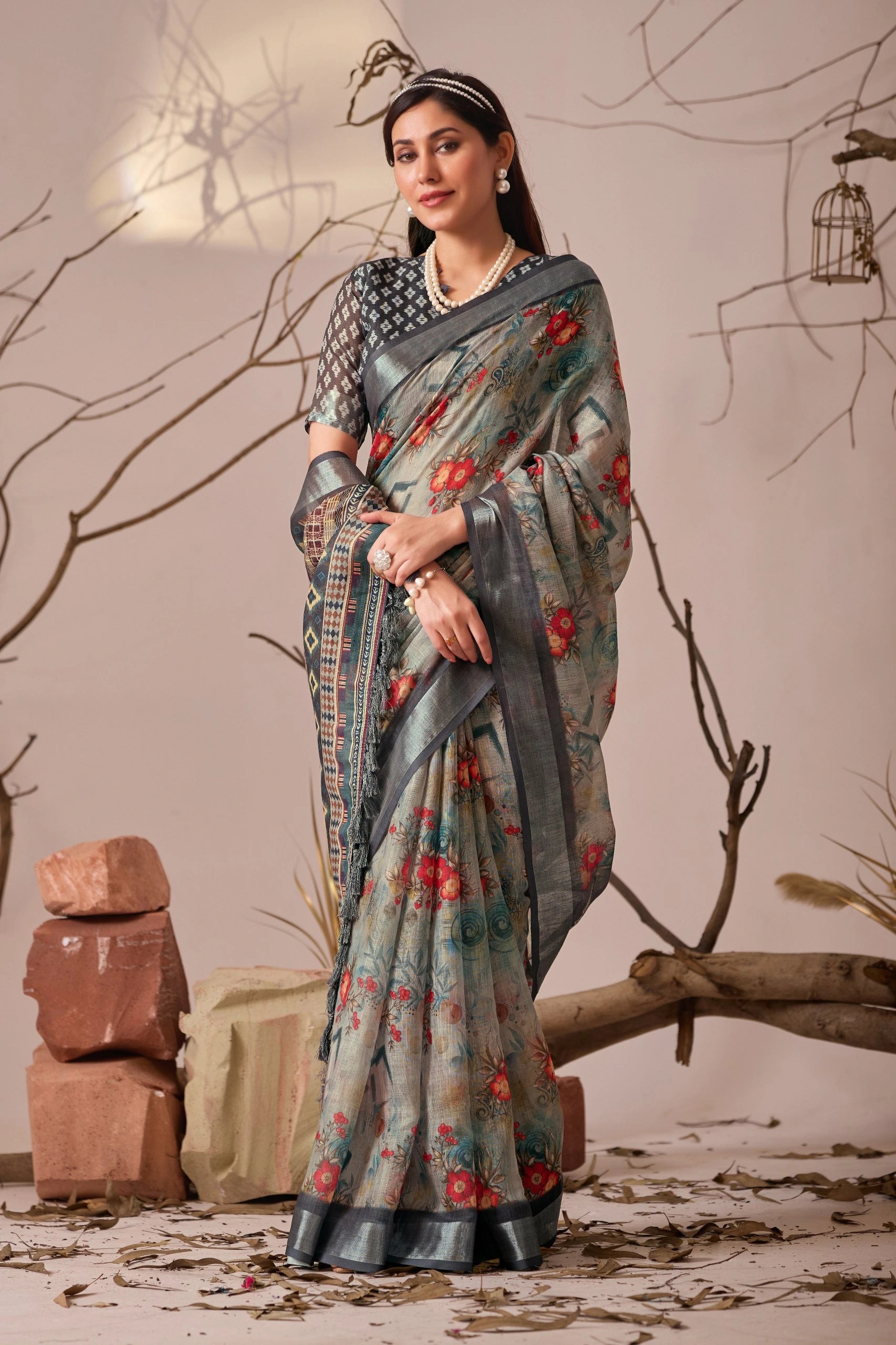 Woman wearing a floral saree with a neutral background