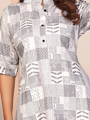 Person wearing a black and white patterned shirt with geometric designs.