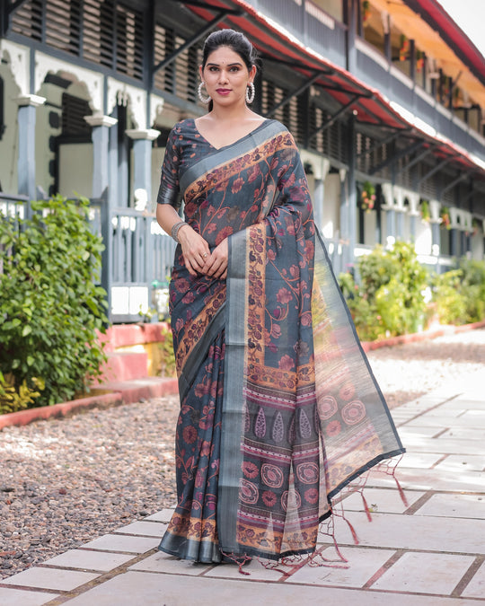 Woman wearing a traditional saree with a patterned design outdoors.