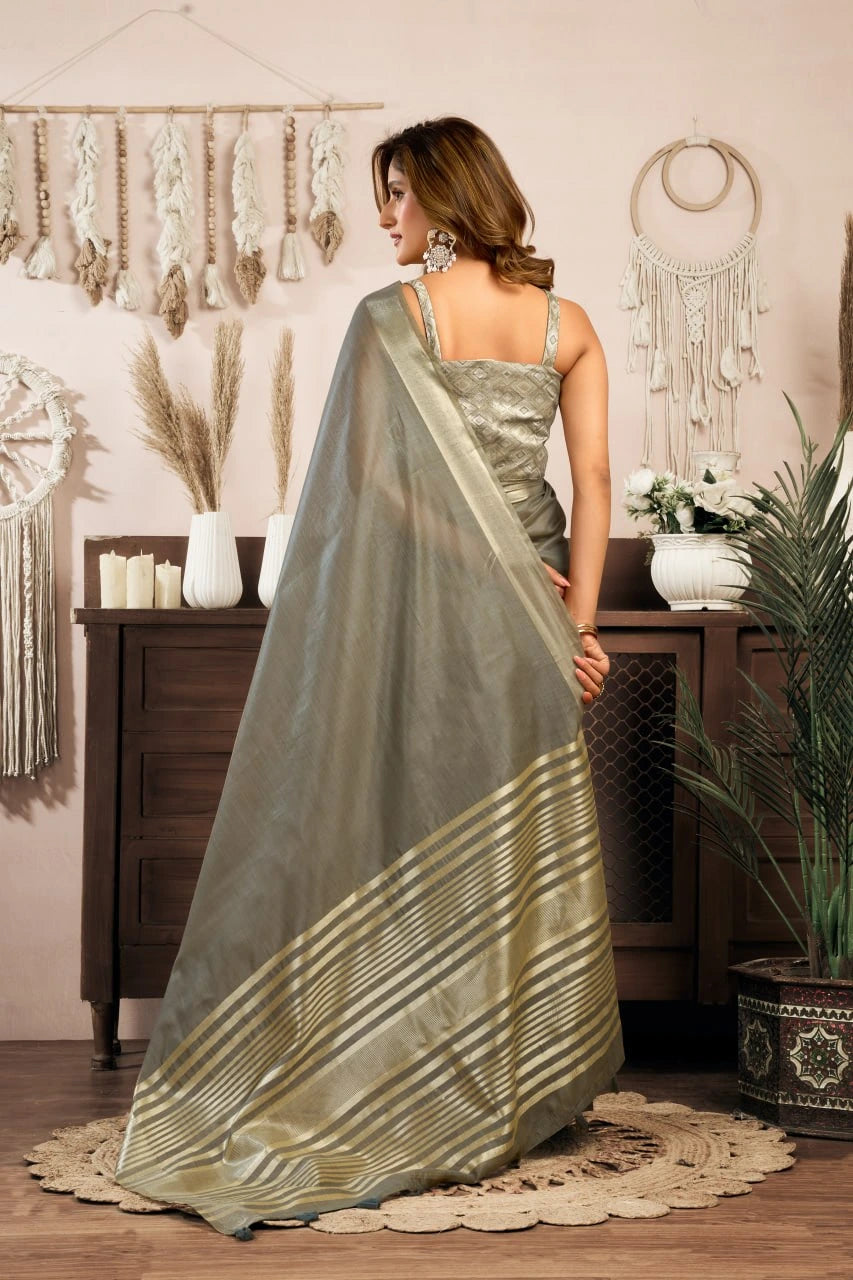 Woman wearing a saree in a room with decorative elements