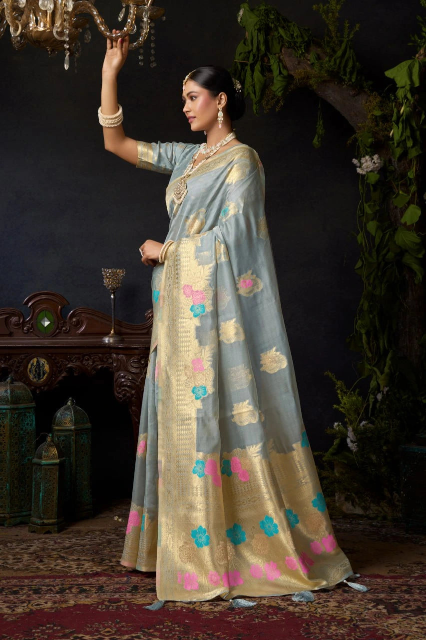 Woman in a traditional outfit with floral patterns standing in a decorated room.