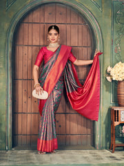 Woman in a traditional saree standing in front of a wooden door