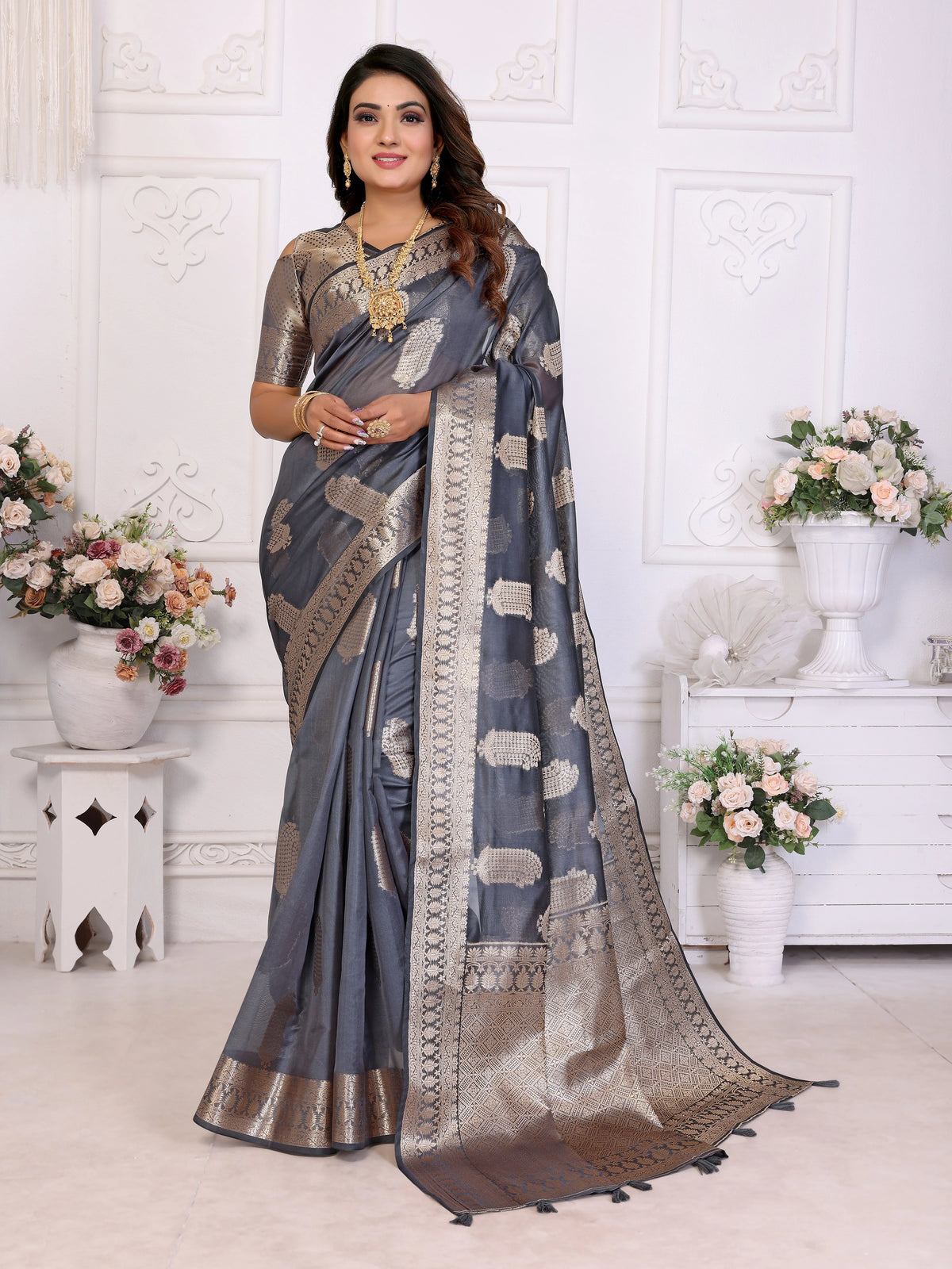 Woman wearing a blue saree with a white background
